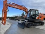 2026 Hitachi ZX130-7H Excavator equipped with hydraulic blade. PSM, Steel Wrist, and Black Max attachment