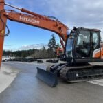 2026 Hitachi ZX130-7H Excavator equipped with hydraulic blade. PSM, Steel Wrist, and Black Max attachment
